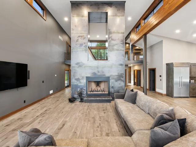 Great room and steel-wrapped fireplace at 88 Lakeview Court