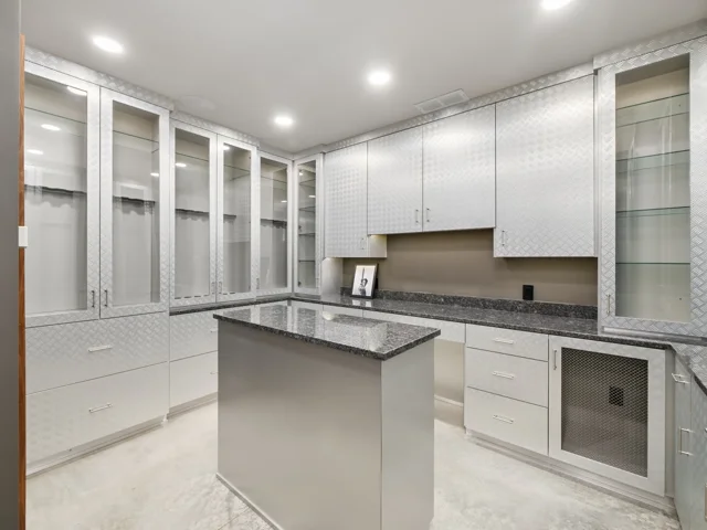 The Collection Room: glass-front cabinetry and central island at 88 Lakeview Court