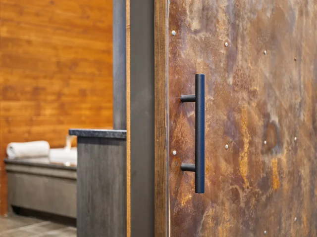Custom sliding door with a distressed-metal finish at 88 Lakeview Court