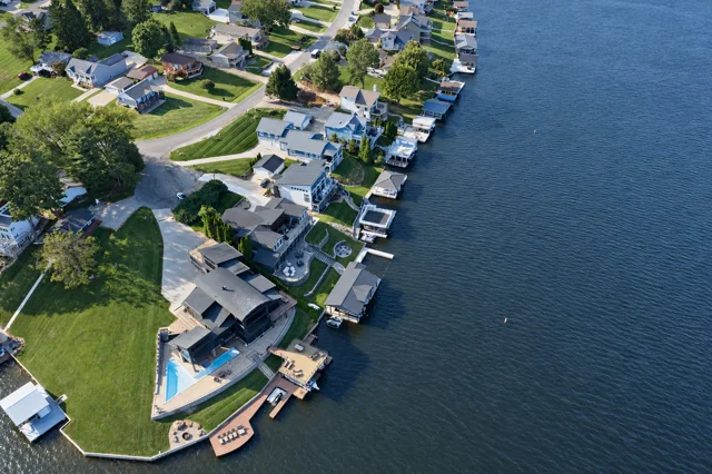 88 Lakeview Court, its pool and dock in the foreground, with neighboring waterfront homes and Apple Valley Lake beyond